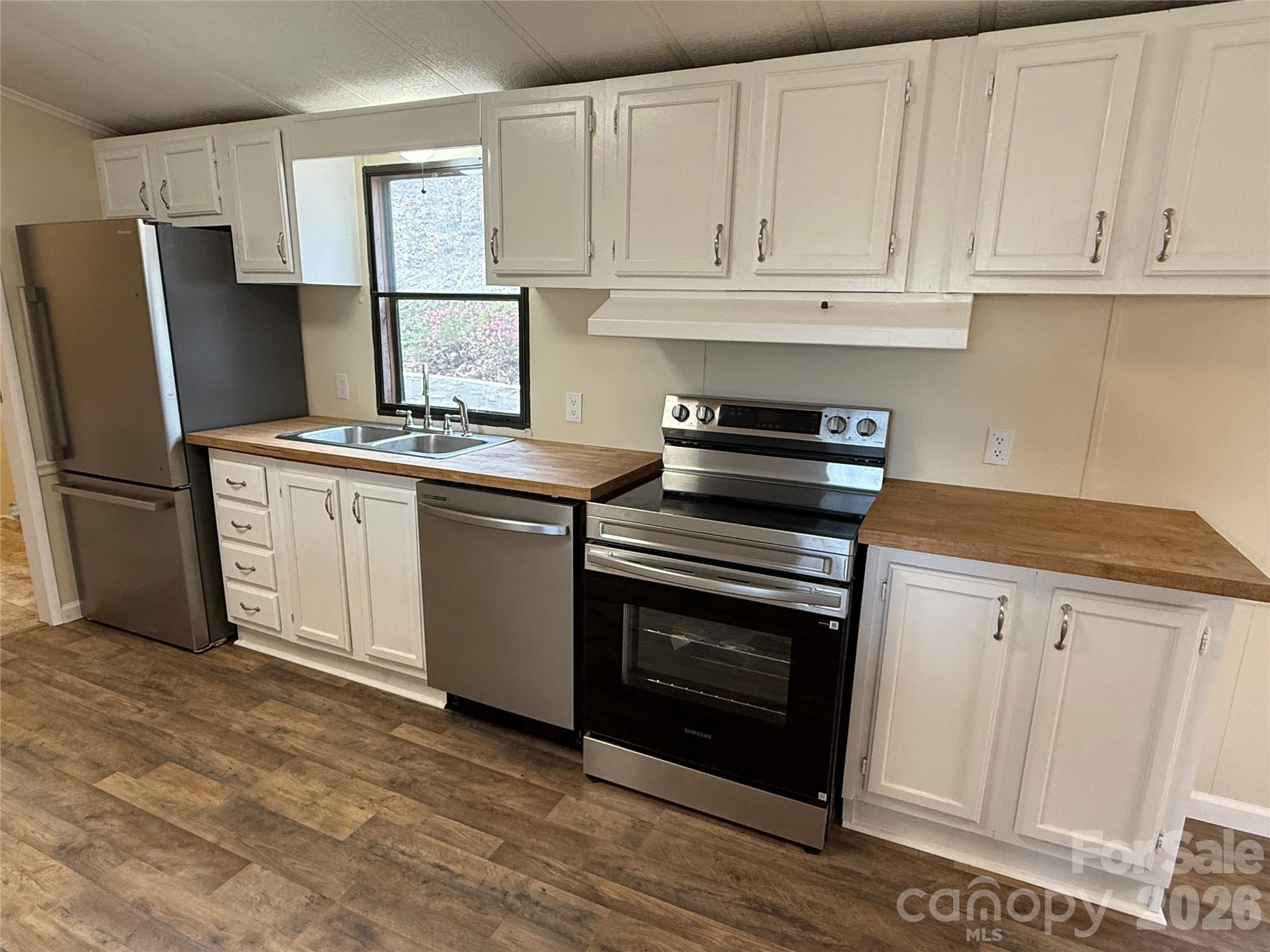 7686 Shoupes Grove Church Road Hickory, NC 28602 - Photo 9 of 36 a kitchen with granite countertop white cabinets and stainless steel appliances