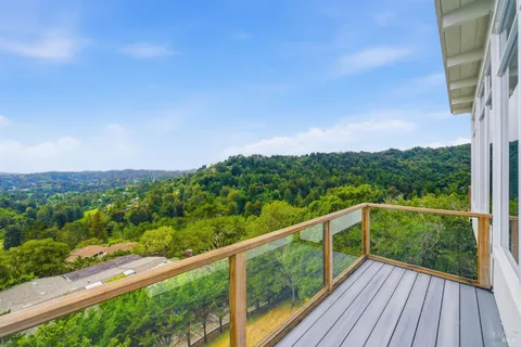 a view of city and mountain from a balcony
