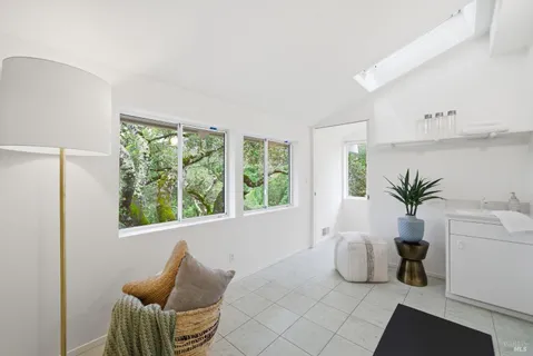 a bedroom with a bed and a potted plant