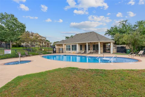 a view of pool with umbrella and trees in the background