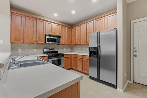 a kitchen with a refrigerator sink and microwave