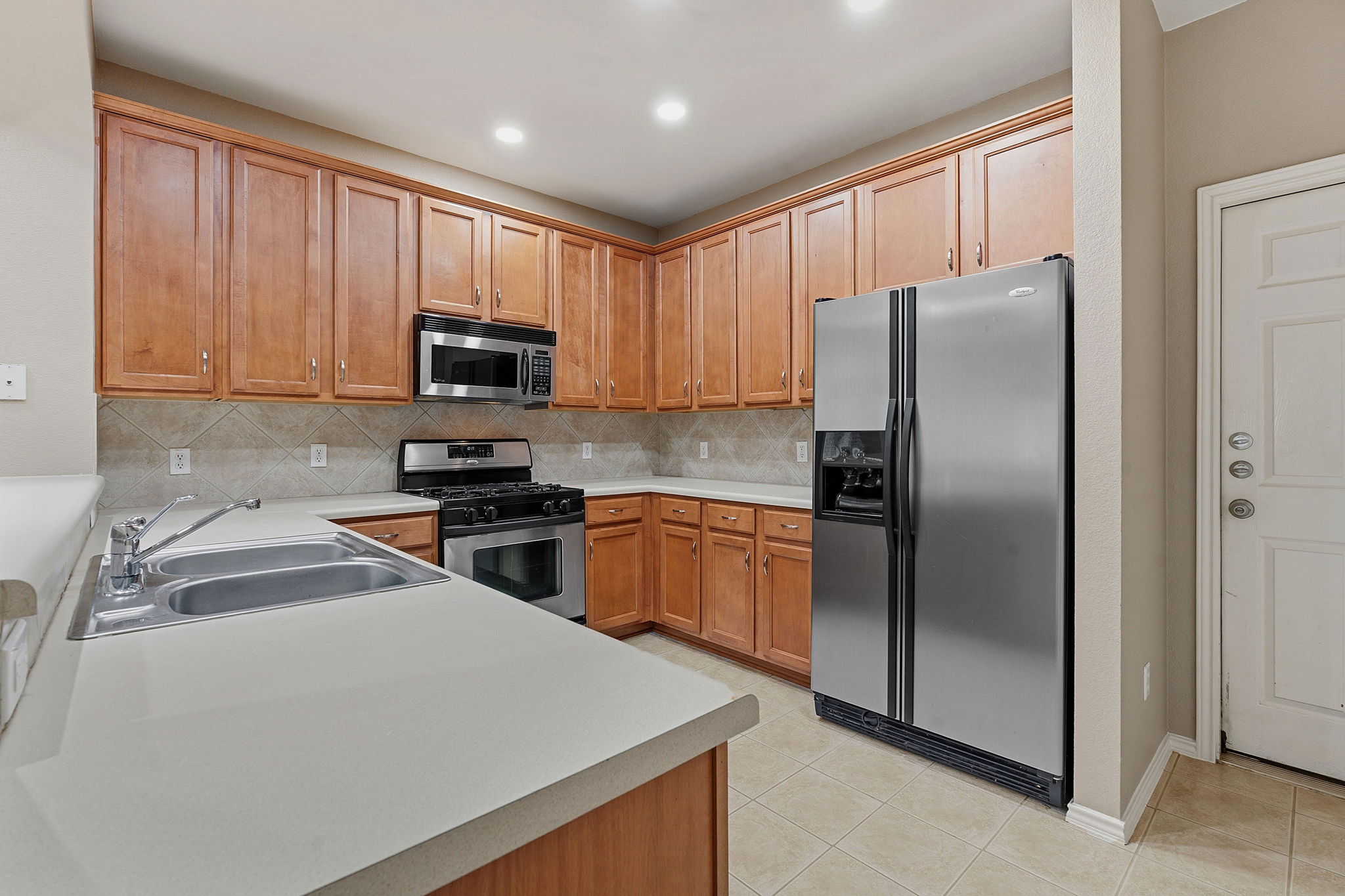 1900 Scofield Ridge Parkway, Unit 3002 Austin, TX 78727 - Photo 9 of 23 a kitchen with a refrigerator sink and microwave