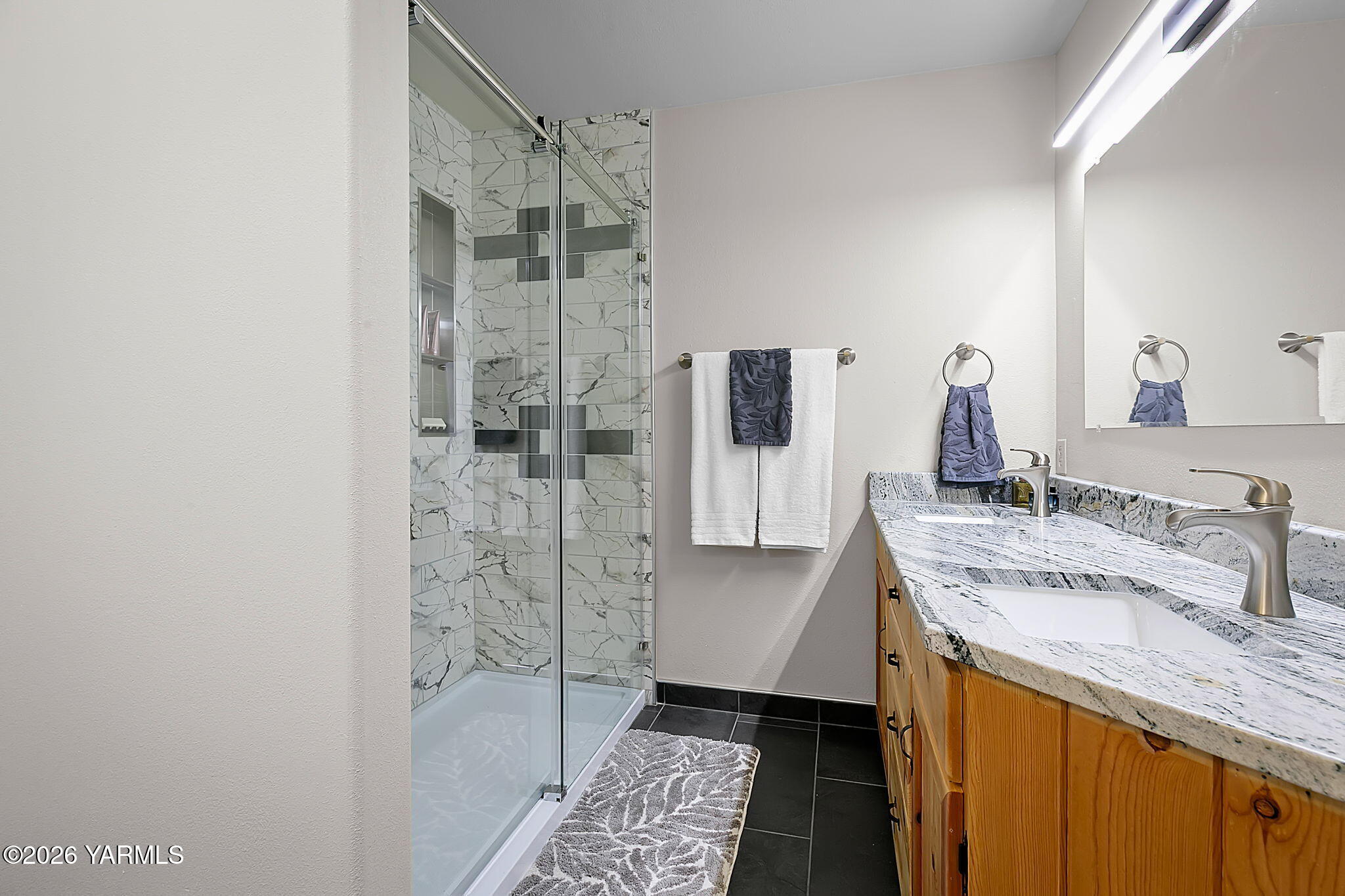 10161 North Wenas Road Selah, WA 98942 - Photo 26 of 48 a bathroom with a granite countertop sink a shower and a mirror