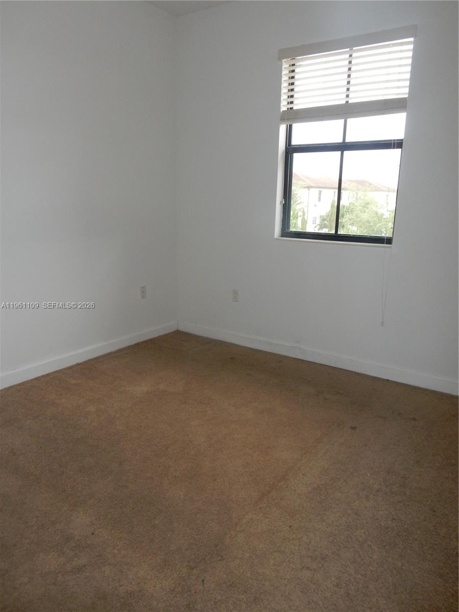 3467 West 89th Terrace Hialeah, FL 33018 - Photo 15 of 33 an empty room with a window