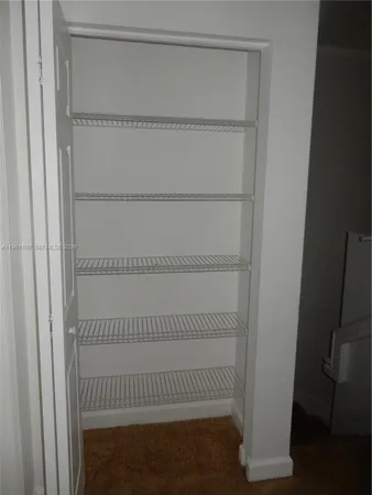 a view of an empty room with staircase