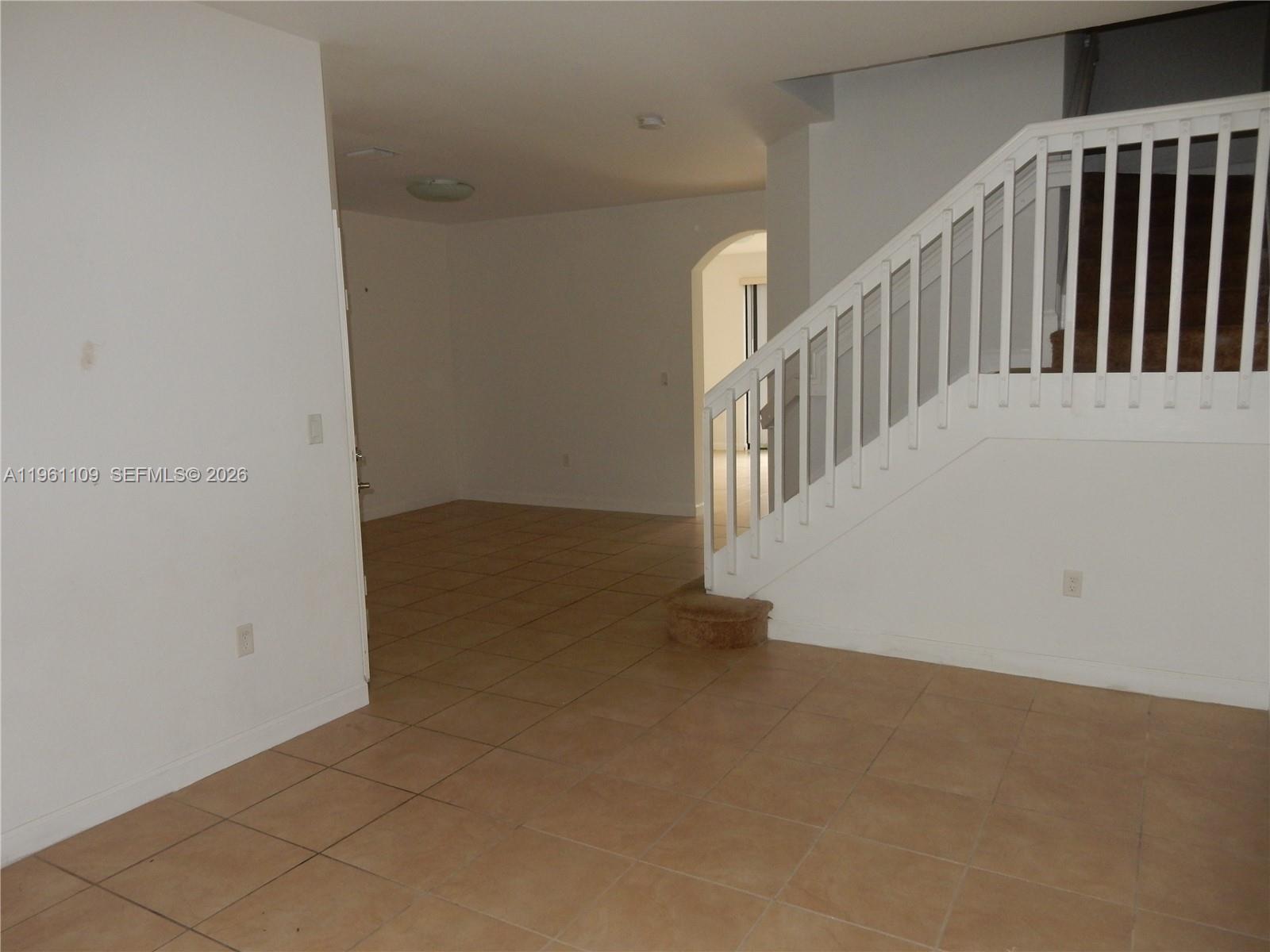 3467 West 89th Terrace Hialeah, FL 33018 - Photo 23 of 33 a view of an empty room with staircase