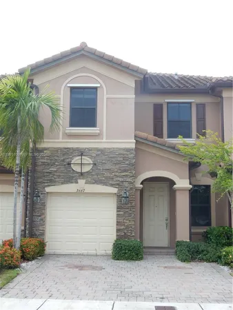a front view of a house with parking space