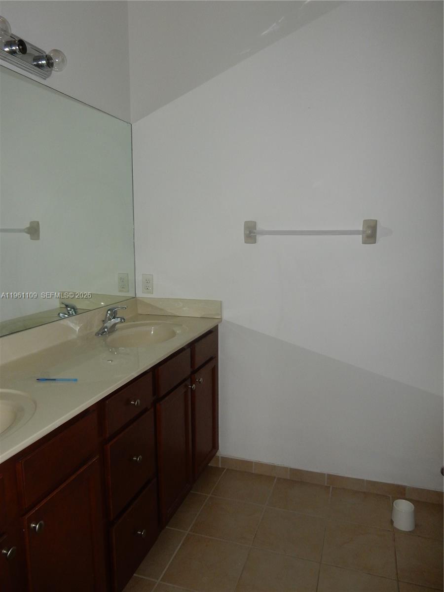 3467 West 89th Terrace Hialeah, FL 33018 - Photo 9 of 33 a bathroom with a sink and a mirror