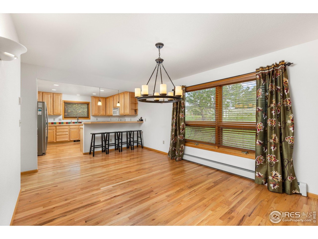 1117 Rock Lake Road Ward, CO 80481 - Photo 10 of 40 Dining area into kitchen with beautiful hardwood floors throughout.