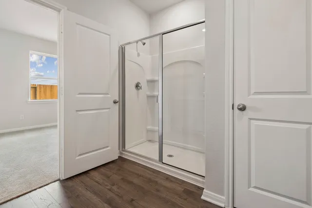 a bathroom with a glass shower door