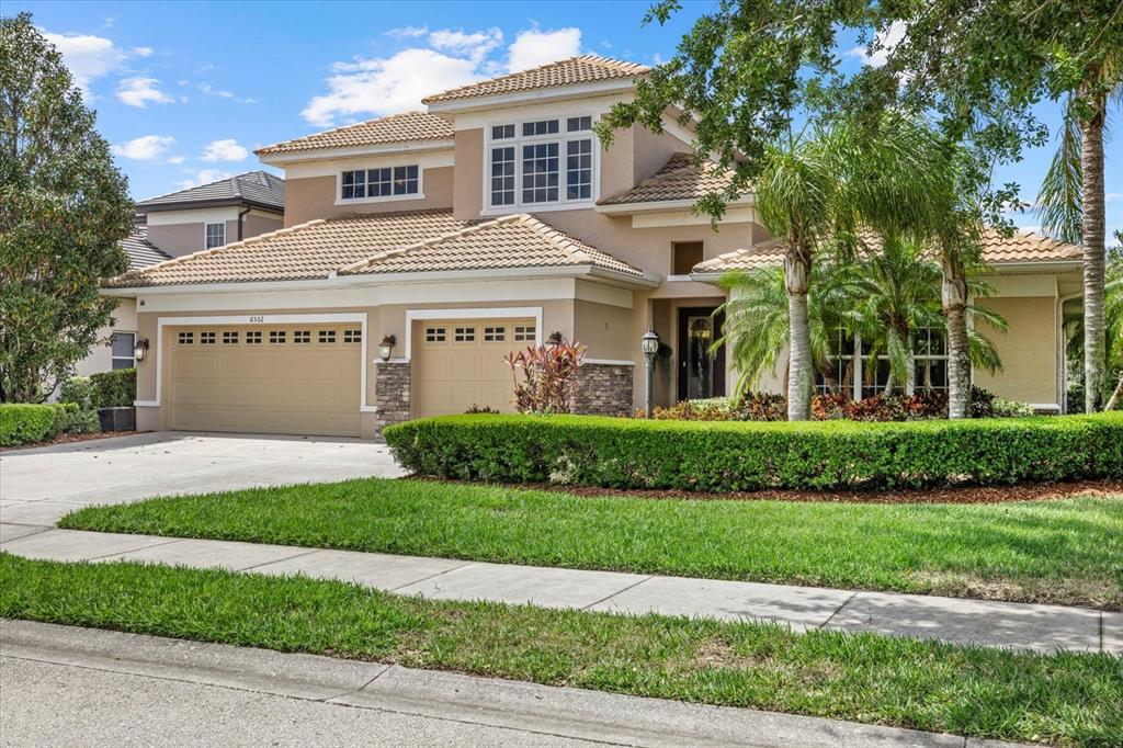 6532 Coopers Hawk Court Lakewood Ranch, FL 34202 - Photo 1 of 1 a front view of a house with a yard
