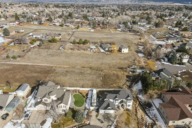 an aerial view of residential houses with outdoor space