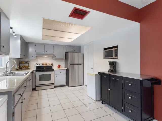 a kitchen with a stove a sink and a refrigerator