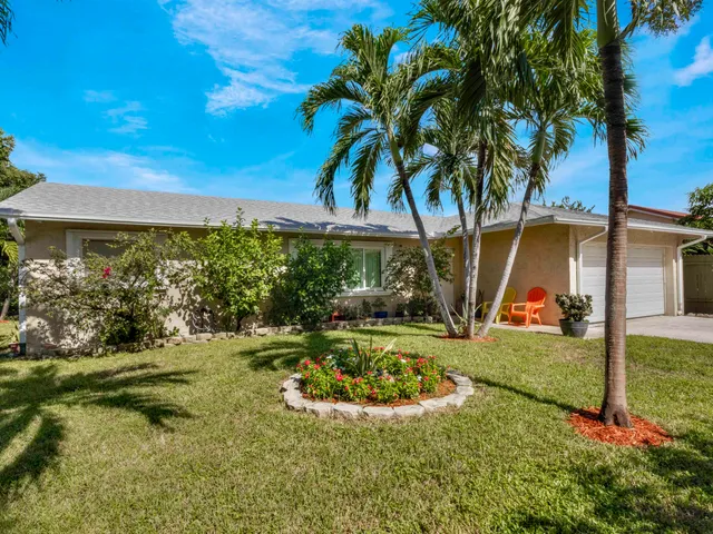 a view of a backyard with swimming pool