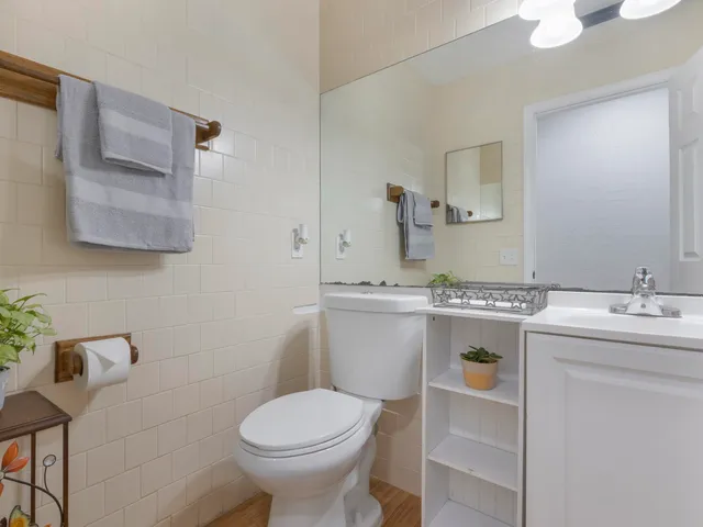 a bathroom with a sink toilet and mirror