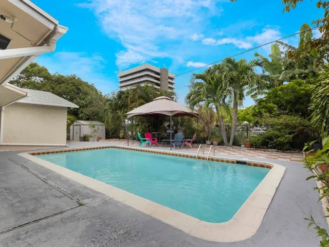 a view of a swimming pool and lounge chairs