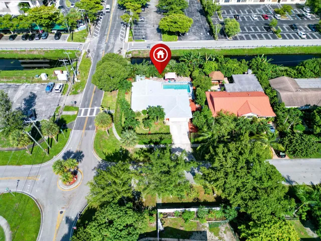 an aerial view of a pool yard and outdoor seating