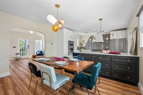 a view of a dining room with furniture and chandelier