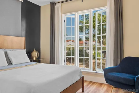 a bed sitting in a bedroom next to a window