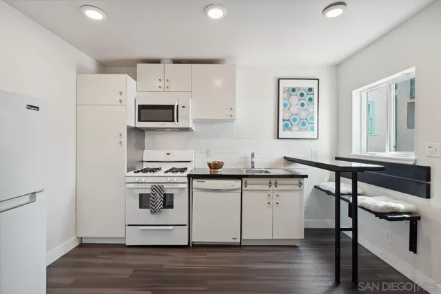 a view of a house with a yard and potted plants