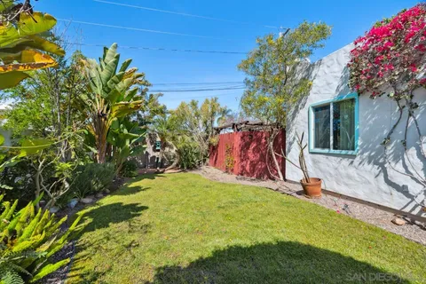 a kitchen with granite countertop a sink and a refrigerator