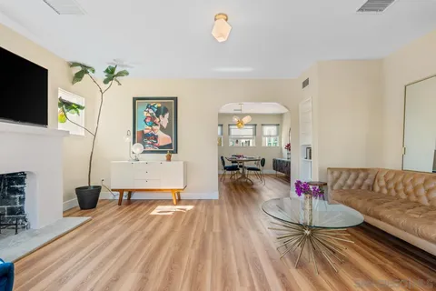 a living room with furniture and a wooden floor