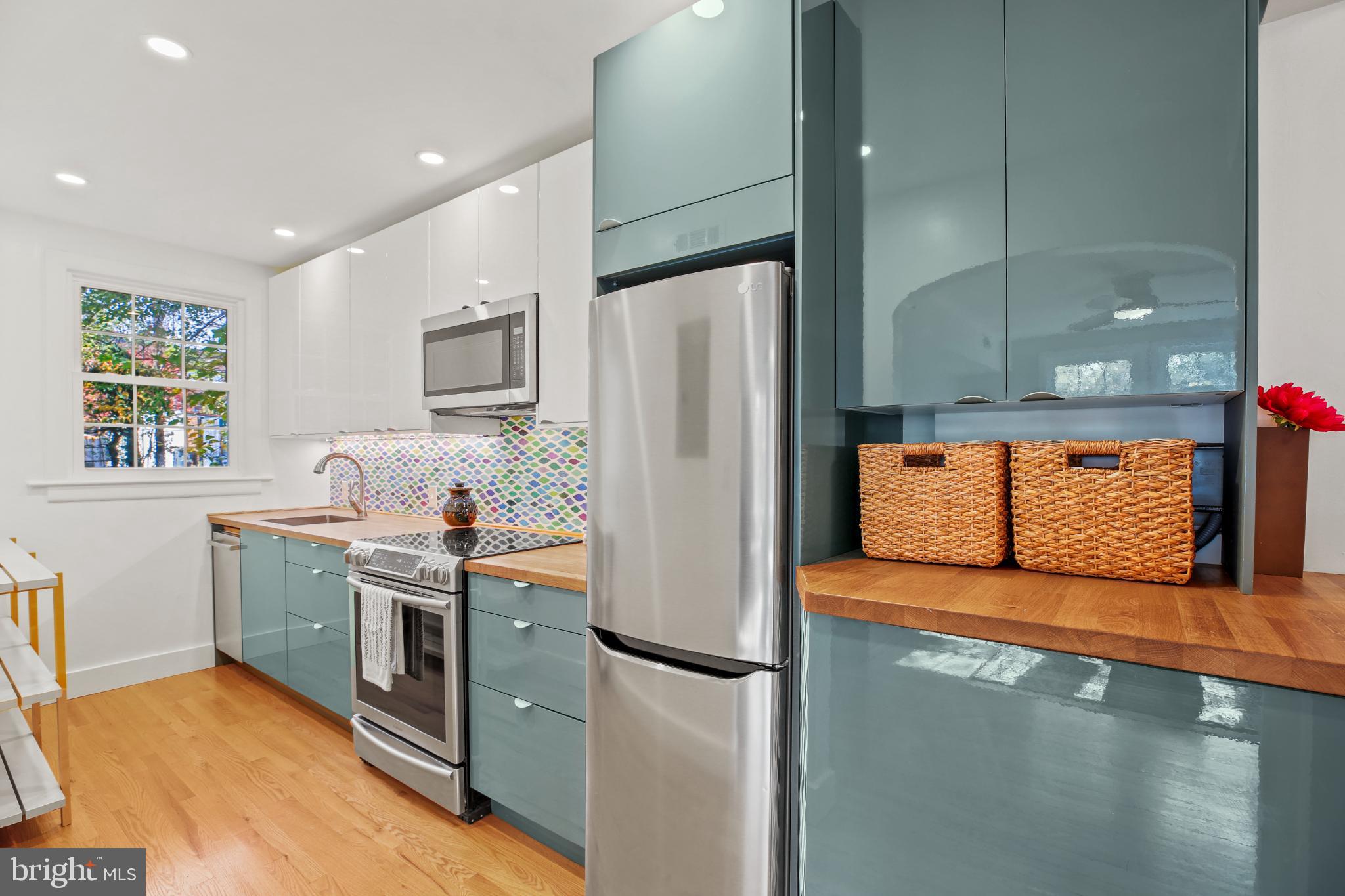318 Rhode Island Avenue Northeast, Unit 101 Washington, DC 20002 - Photo 2 of 33 a kitchen with stainless steel appliances granite countertop a refrigerator a stove and a sink