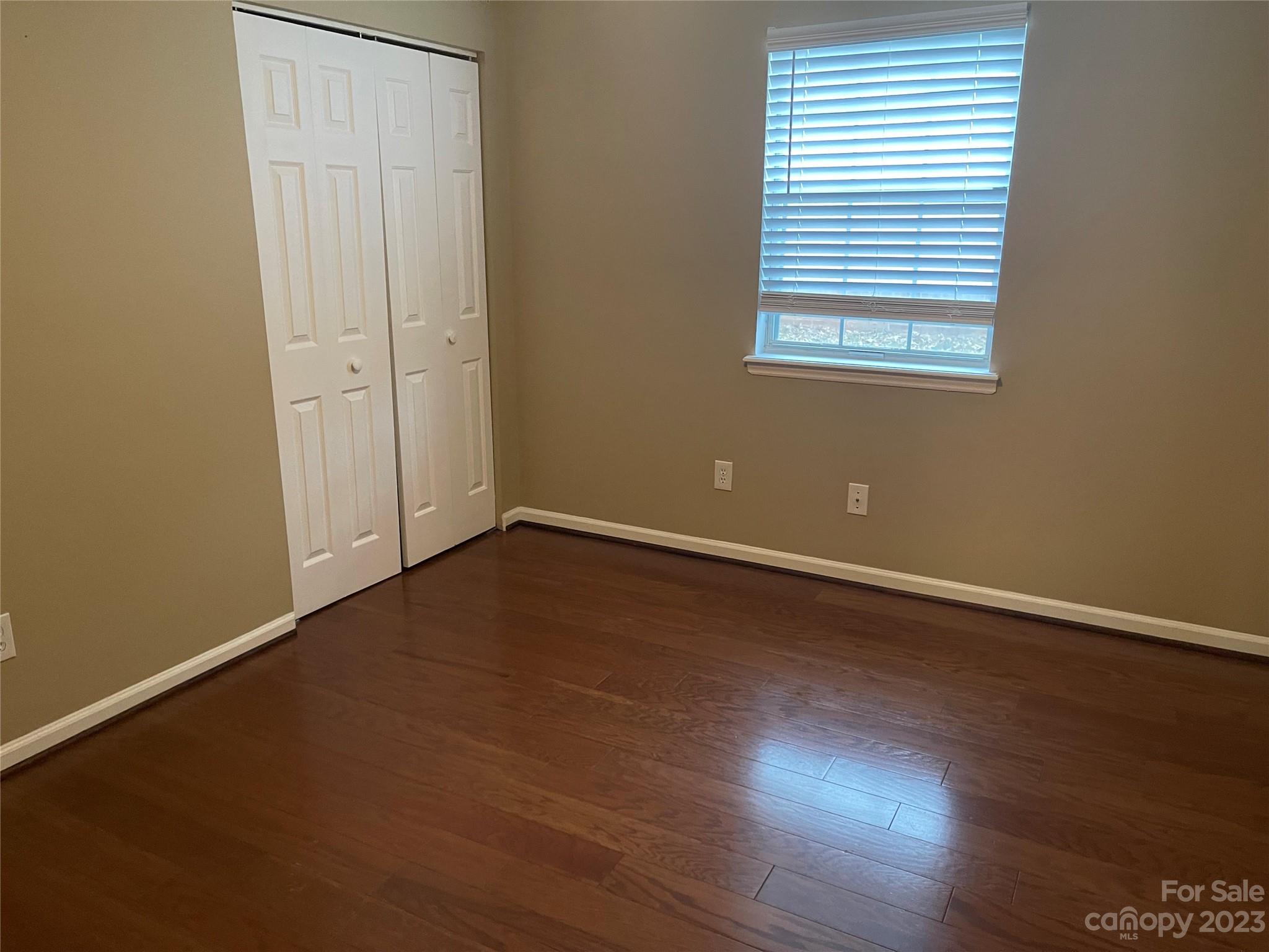 10427 Fairway Ridge Road Charlotte, NC 28277 - Photo 18 of 21 an empty room with wooden floor and windows