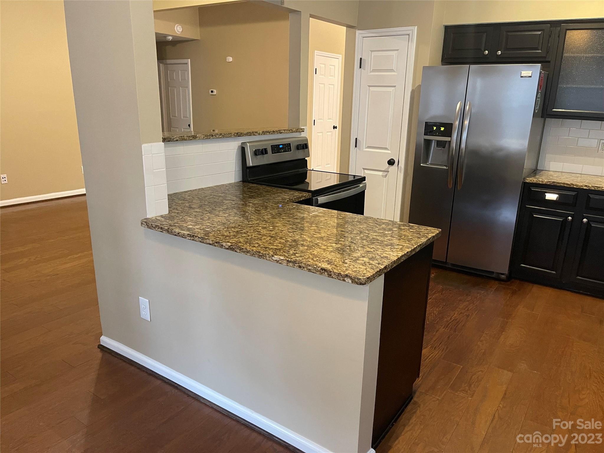 10427 Fairway Ridge Road Charlotte, NC 28277 - Photo 8 of 21 a kitchen with stainless steel appliances granite countertop a refrigerator a sink and a stove