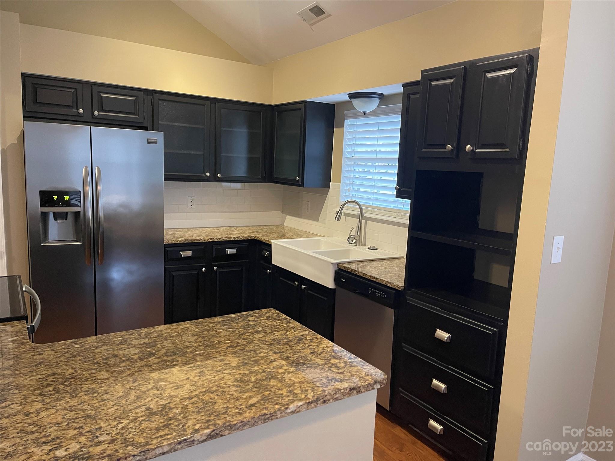 10427 Fairway Ridge Road Charlotte, NC 28277 - Photo 9 of 21 a kitchen with a refrigerator and a sink