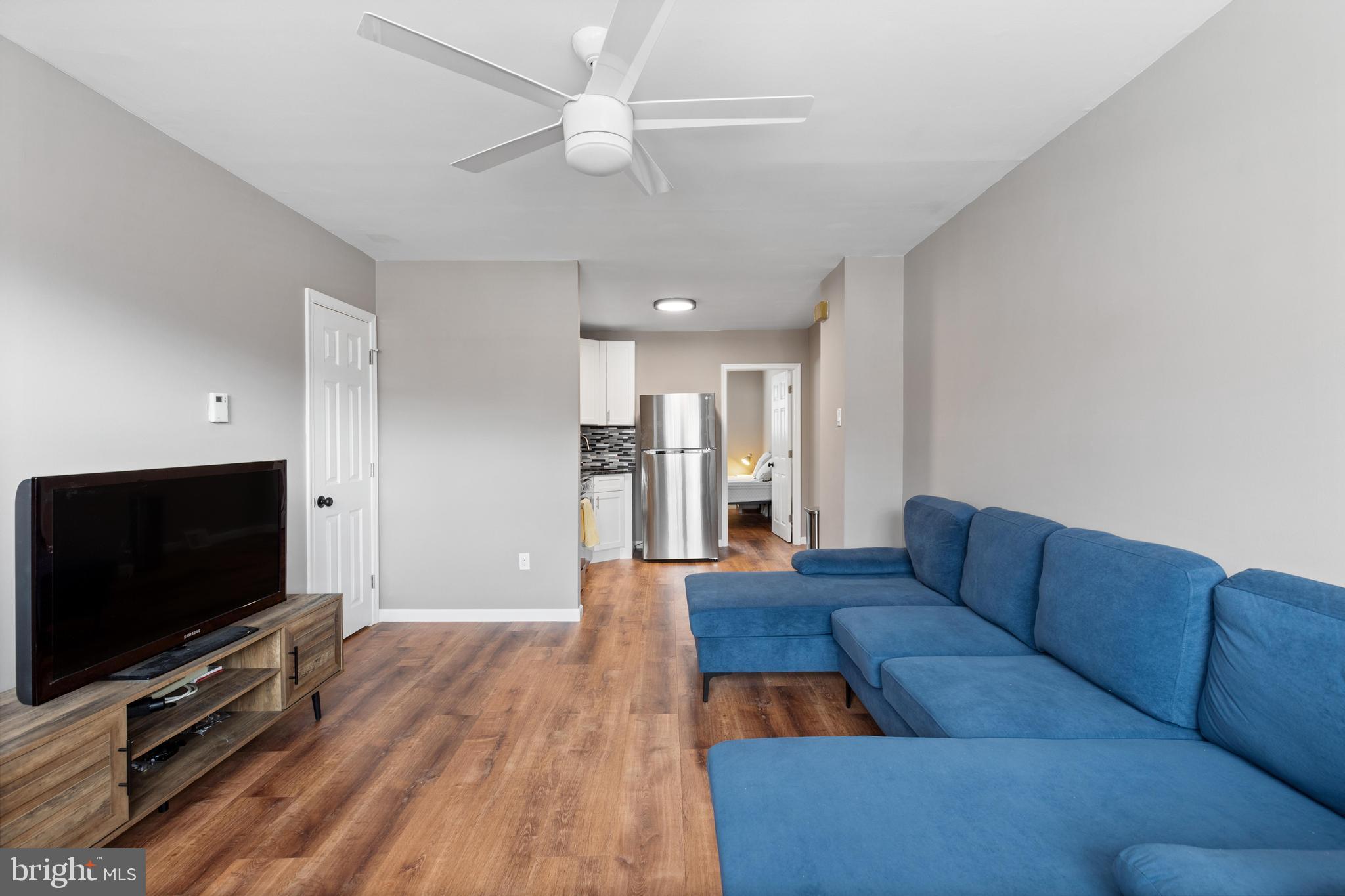 331 Ripka Street, Unit 1 Philadelphia, PA 19128 - Photo 2 of 8 a living room with furniture and a flat screen tv