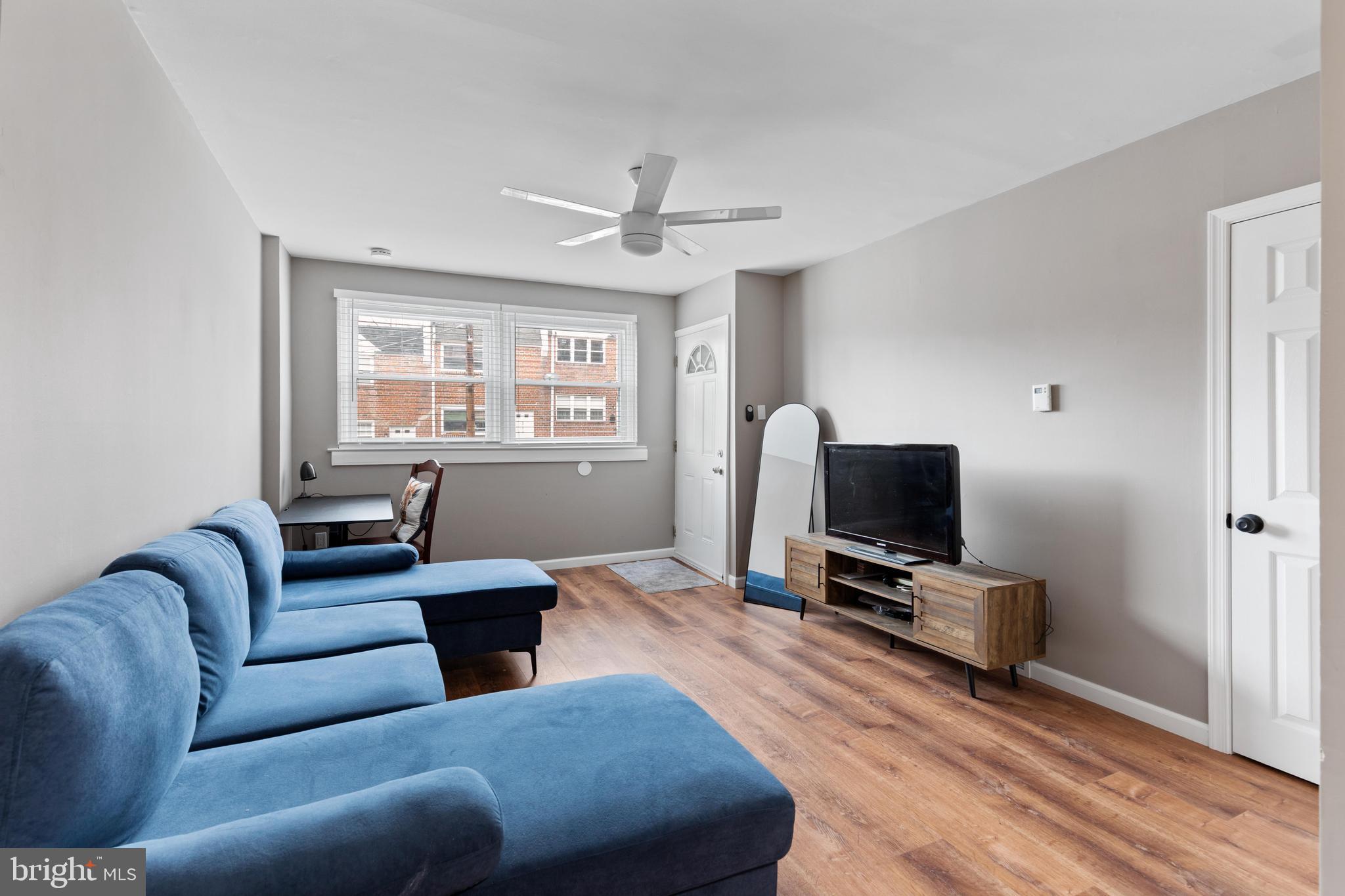 331 Ripka Street, Unit 1 Philadelphia, PA 19128 - Photo 3 of 8 a living room with furniture a flat screen tv and a window