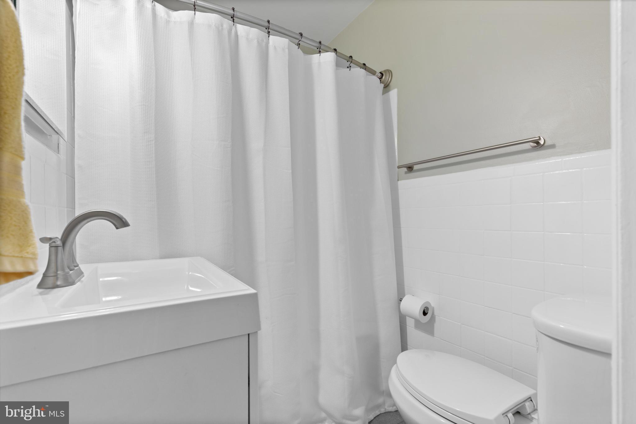 331 Ripka Street, Unit 1 Philadelphia, PA 19128 - Photo 6 of 8 a bathroom with a sink a toilet and shower