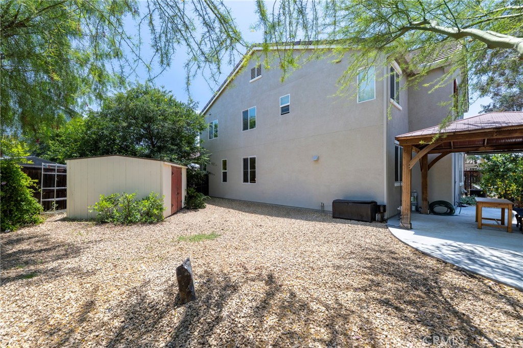 3819 St Austell Way Perris, CA 92571 - Photo 58 of 64 a backyard of a house with yard and outdoor seating