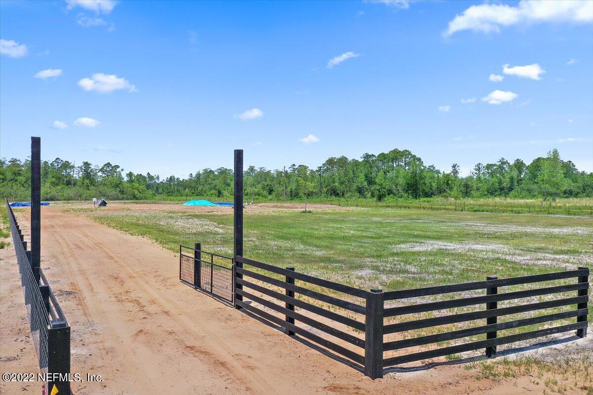 17444 Co Road Bryceville, FL 32009 - Photo 16 of 17 a view of a lake with a yard and a large tree