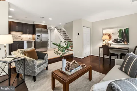 a living room with furniture and a wooden floor