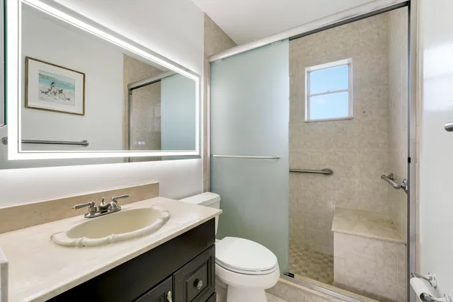 a bathroom with a sink toilet and a mirror