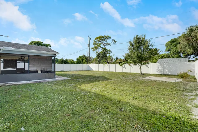 a view of three house with a big yard