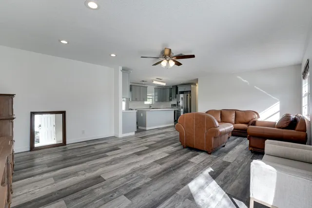 a living room with furniture and kitchen view