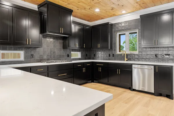 a kitchen with a sink a stove and cabinets