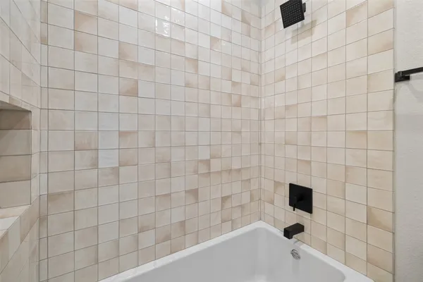 a bathroom with a bathtub and shower