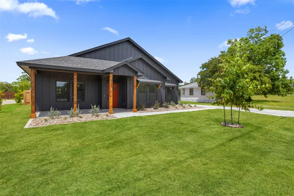 a front view of a house with a yard
