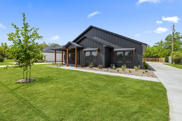 a front view of house with yard and green space