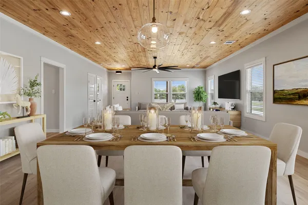 a dining room with furniture a flat screen tv and a clock