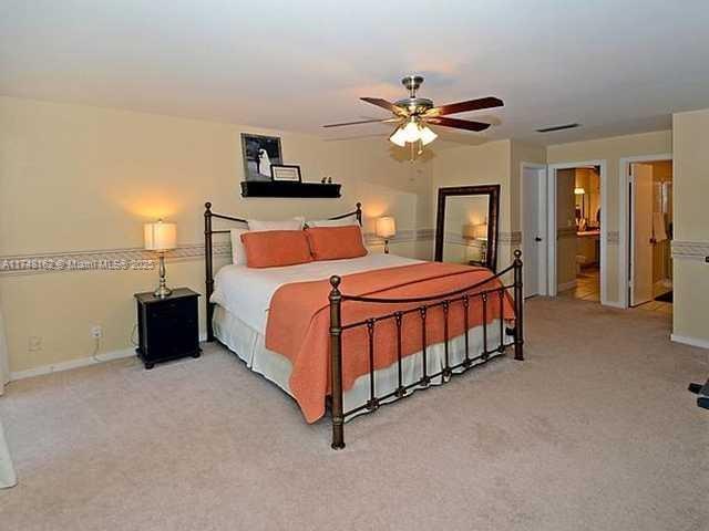 720 Mockingbird Lane Plantation, FL 33324 - Photo 12 of 12 a bedroom with a bed and a chandelier