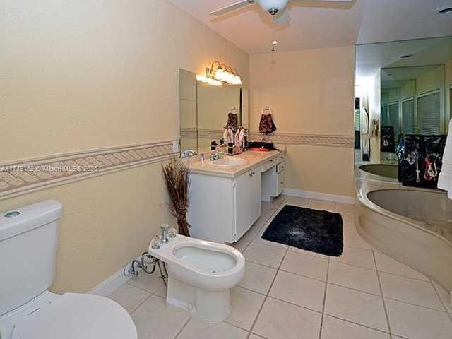 720 Mockingbird Lane Plantation, FL 33324 - Photo 10 of 12 a bathroom with a sink a toilet and mirror