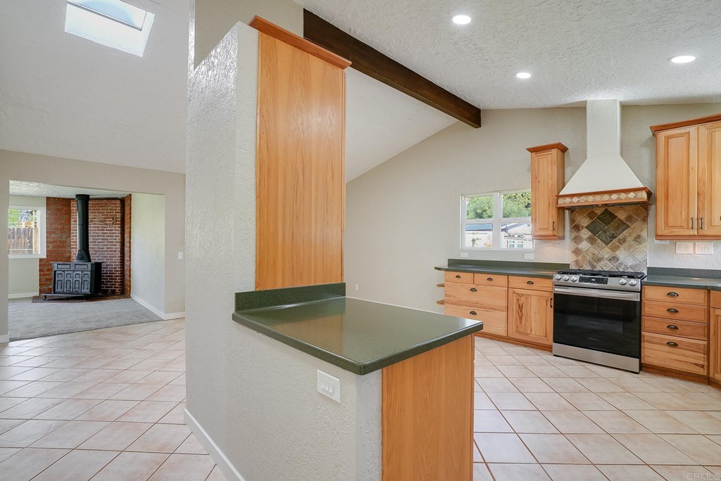 225 Hypoint Place Escondido, CA 92027 - Photo 11 of 63 a kitchen with stainless steel appliances granite countertop a sink and a stove top oven