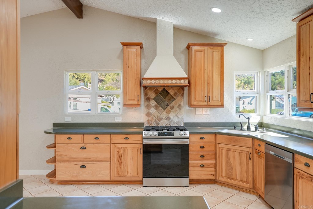 225 Hypoint Place Escondido, CA 92027 - Photo 12 of 63 a kitchen with stainless steel appliances granite countertop a stove and a sink