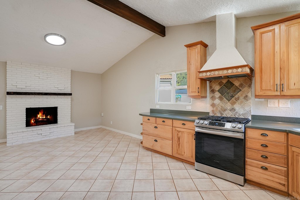 225 Hypoint Place Escondido, CA 92027 - Photo 14 of 63 a kitchen with granite countertop a stove top oven cabinetry and utility room
