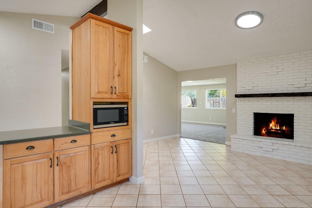 225 Hypoint Place Escondido, CA 92027 - Photo 15 of 63 a view of a kitchen with a sink a fireplace and a window